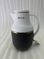 Three 1-liter Feenik thermal flasks in charcoal, taupe, and gray colors with gold trim on a marble kitchen countertop.