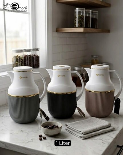 Three 1-liter Feenik thermal flasks in charcoal, taupe, and gray colors with gold trim on a marble kitchen countertop.
