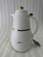 Three DayDays 1-liter luxury thermal flasks in white, black, and purple with gold accents displayed on a granite kitchen countertop.