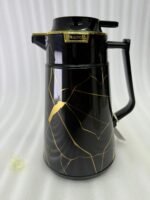 Three elegant 1-liter vacuum flasks in black, grey, and cream colors, featuring a golden Kintsugi-inspired marble pattern on a kitchen countertop.