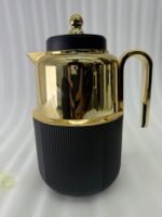 Three luxury 1-liter thermal flasks in white, grey, and black with polished gold tops and ribbed textured bases on a marble kitchen counter.