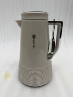 A trio of Feenik 1-liter thermal vacuum flasks in cream, sand grey, and mocha colors, displayed on a marble kitchen countertop.