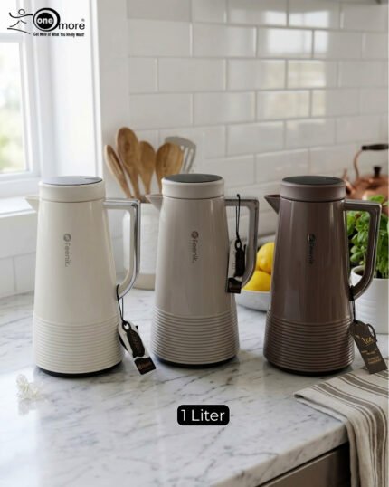 A trio of Feenik 1-liter thermal vacuum flasks in cream, sand grey, and mocha colors, displayed on a marble kitchen countertop.