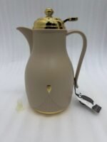 Three 1-liter thermal flasks in grey, beige, and white featuring matte finishes, elegant gold lids, and ergonomic handles on a marble countertop.
