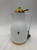 Three 1-liter thermal flasks in grey, beige, and white featuring matte finishes, elegant gold lids, and ergonomic handles on a marble countertop.