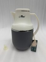 Three 1-liter modern vacuum flasks with cream-colored tops and ribbed bases in brown, grey, and beige, displayed on a white marble kitchen countertop.