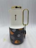 A trio of Feenik 1-liter luxury thermal flasks in cream with gold handles and lids, featuring three different artistic patterns on the base, displayed on a white marble kitchen counter.