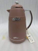 Three 1-liter DayDays thermal flasks in Dusty Rose, Warm Sand, and Stone Grey arranged on a granite kitchen countertop.