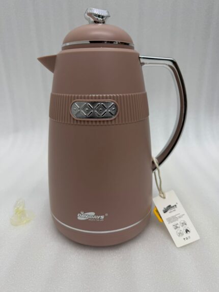 Three 1-liter DayDays thermal flasks in Dusty Rose, Warm Sand, and Stone Grey arranged on a granite kitchen countertop.