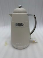 Three 1-liter DayDays thermal flasks in Dusty Rose, Warm Sand, and Stone Grey arranged on a granite kitchen countertop.