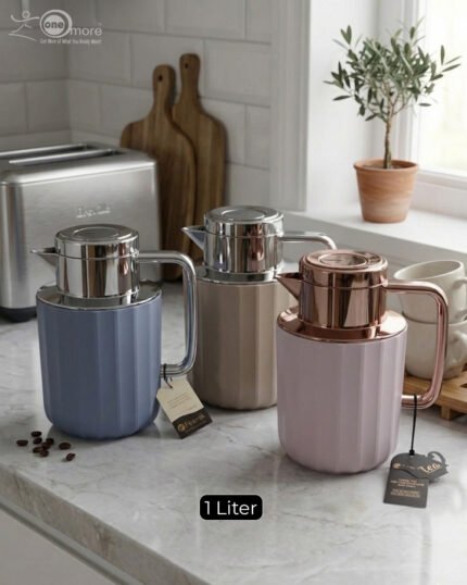Three 1-liter Nordic-style thermal flasks in Slate Blue, Sand Beige, and Soft Rose colors with fluted textures and metallic lids displayed on a kitchen counter.