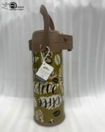 A 1.9-liter olive green Day Days vacuum insulated coffee airpot with a brown pump-action lid and handle, featuring a decorative coffee bean pattern, displayed on a kitchen counter next to a coffee cup.