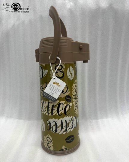 A 1.9-liter olive green Day Days vacuum insulated coffee airpot with a brown pump-action lid and handle, featuring a decorative coffee bean pattern, displayed on a kitchen counter next to a coffee cup.