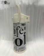 A 1.9-liter Day Days vacuum insulated airpot with a floral garden pattern and brown pump-action lid, standing on a kitchen counter with a blurred home background.