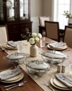 Three Paramount Series glass and stainless steel food warmers in 1.5L, 2L, and 3L sizes arranged on a dining table with tea light candles lit underneath.