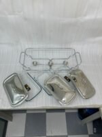 A professional Paramount Series 3-in-1 stainless steel food warmer with three 1.5L glass containers and polished metal lids, displayed on a kitchen counter and a dining table with various dishes.