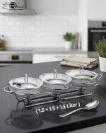 Three-section stainless steel food warmer from the Paramount Series featuring three 1.5L glass bowls with metal lids on a silver wire rack with tea light candle burners underneath.