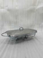 Three elegant Paramount Series food warmers in different sizes (1.5L, 2.4L, and 3L) featuring stainless steel lids and glass dishes with candle-lit buffet burners on a dining table.