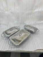 Three elegant Paramount Series food warmers in different sizes (1.5L, 2.4L, and 3L) featuring stainless steel lids and glass dishes with candle-lit buffet burners on a dining table.