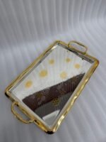 A set of three luxury Onemore brand stainless steel serving trays with gold-textured handles and borders, featuring etched floral patterns on a mirror-polished surface, displayed on a dark wooden dining table.