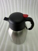 Stainless Steel Thermal Flask with a black lid and handle, available in 1.5 liter and 2 liter sizes, shown on a kitchen countertop.