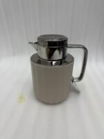 Three 1-liter Nordic-style thermal flasks in Slate Blue, Sand Beige, and Soft Rose colors with fluted textures and metallic lids displayed on a kitchen counter.