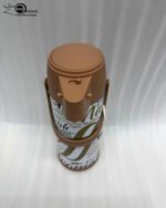 A 1.9-liter Day Days thermal airpot with a brown pump lid and a white body featuring coffee-themed typography, sitting on a marble kitchen countertop.