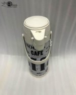 A 1.9-liter Day Days vacuum insulated airpot with a floral garden pattern and brown pump-action lid, standing on a kitchen counter with a blurred home background.