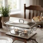 Three elegant Paramount Series food warmers in different sizes (1.5L, 2.4L, and 3L) featuring stainless steel lids and glass dishes with candle-lit buffet burners on a dining table.