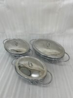 Three Paramount Series glass and stainless steel food warmers in 1.5L, 2L, and 3L sizes arranged on a dining table with tea light candles lit underneath.