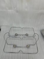 A luxurious Paramount Series 5-in-1 food warmer set on a wooden dining table, featuring four 2.5L glass serving dishes with polished stainless steel lids and tealight buffet burners underneath.