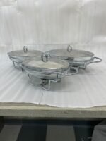 Three Paramount Series glass and stainless steel food warmers in 1.5L, 2L, and 3L sizes arranged on a dining table with tea light candles lit underneath.