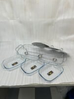 A Paramount Series 3-in-1 buffet food warmer featuring three square glass serving dishes with stainless steel lids on a chrome wire rack, displayed on a kitchen counter and an outdoor dining table with tea light candles lit underneath.