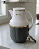 Three 1-liter Feenik thermal flasks in charcoal, taupe, and gray colors with gold trim on a marble kitchen countertop.