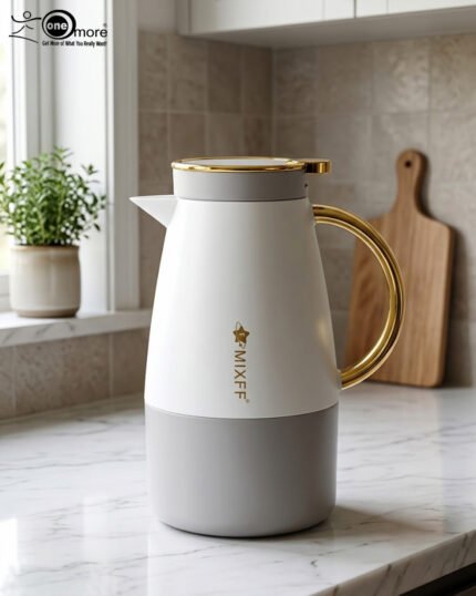 Three elegant 1.5-liter stainless steel thermal flasks in rose gold, slate grey, and charcoal blue bases with white bodies and gold-plated handles, displayed on a marble kitchen countertop.