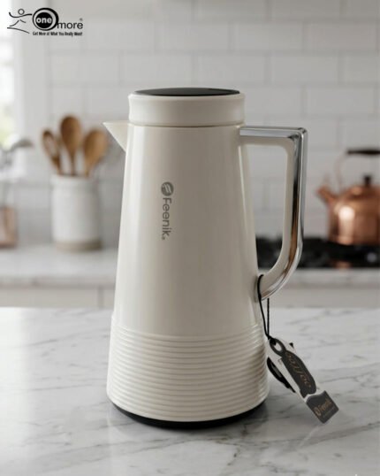 A trio of Feenik 1-liter thermal vacuum flasks in cream, sand grey, and mocha colors, displayed on a marble kitchen countertop.