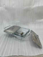 A Paramount Series 2-in-1 stainless steel food warmer with two 1.5-liter glass serving dishes and dual buffet burners, displayed on a marble kitchen countertop.