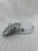 A luxurious Paramount Series 5-in-1 food warmer set on a wooden dining table, featuring four 2.5L glass serving dishes with polished stainless steel lids and tealight buffet burners underneath.