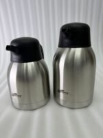 Stainless Steel Thermal Flask with a black lid and handle, available in 1.5 liter and 2 liter sizes, shown on a kitchen countertop.