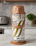 A 1.9-liter Day Days thermal airpot with a brown pump lid and a white body featuring coffee-themed typography, sitting on a marble kitchen countertop.