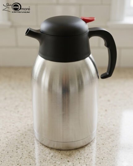 Stainless Steel Thermal Flask with a black lid and handle, available in 1.5 liter and 2 liter sizes, shown on a kitchen countertop.