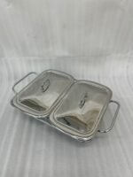 A Paramount Series 2-in-1 stainless steel food warmer with two 1.5-liter glass serving dishes and dual buffet burners, displayed on a marble kitchen countertop.