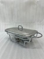 Three elegant Paramount Series food warmers in different sizes (1.5L, 2.4L, and 3L) featuring stainless steel lids and glass dishes with candle-lit buffet burners on a dining table.