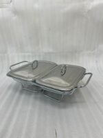 A Paramount Series 2-in-1 stainless steel food warmer with two 1.5-liter glass serving dishes and dual buffet burners, displayed on a marble kitchen countertop.