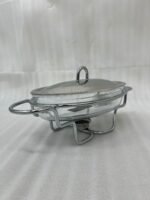 Three Paramount Series glass and stainless steel food warmers in 1.5L, 2L, and 3L sizes arranged on a dining table with tea light candles lit underneath.