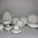 A comprehensive 61-piece Super Bone China dinner set featuring a white finish with a beige leaf pattern border and silver rims, arranged against a neutral background.