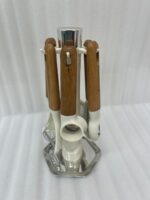A 7-piece kitchen gadget set featuring cream-colored heads and ergonomic wooden handles, displayed both individually and hanging on a matching rotating stand on a marble countertop.
