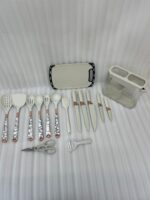 A comprehensive 16-piece kitchen tool set featuring cream-colored silicone utensils with marble-patterned handles, rose gold accents, a matching knife set, kitchen shears, a peeler, and a cutting board, all stored in a clear geometric organizer.