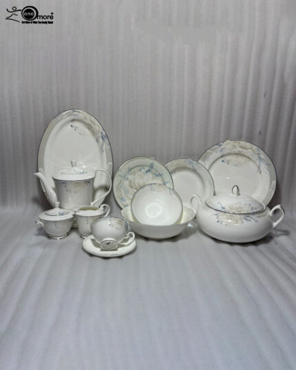 A comprehensive 61-piece super bone china dinner set for an 8-person serving, displayed on a wooden table against a neutral background. The white ceramic tableware features a delicate light blue and grey floral pattern with thin silver rims. The set includes a large oval platter, dinner plates, side plates, soup bowls, a covered casserole dish, a teapot, a creamer, a sugar bowl, and tea cups with saucers.