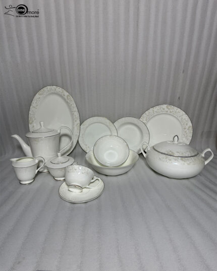 Detailed product photograph of an elegant 61-piece super bone china dinner set for 8-person serving, displayed on a polished wooden surface. The set includes a full tea service (teapot, creamer, sugar bowl, teacup and saucer), multiple plates and bowls, a large lidded tureen, and various serving pieces, all featuring delicate light gold damask filigree patterns and gold trim on a cream-white surface. The 'one more' brand logo is visible in the upper left corner.